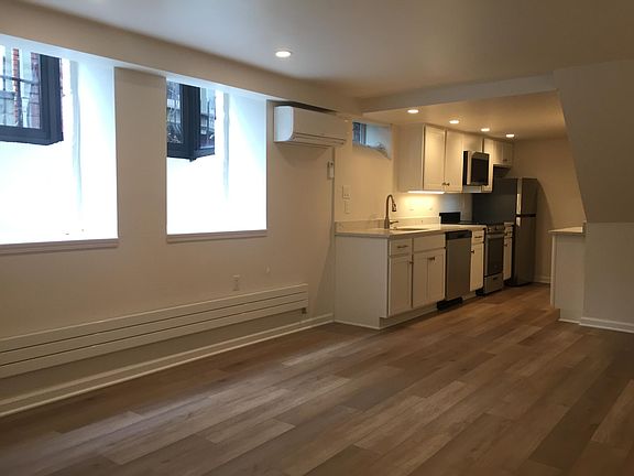 Living Room looking into kitchen and Laundry area.