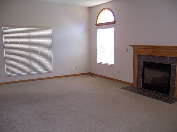 Great Room With Fireplace & Lots Of LIght With Windows