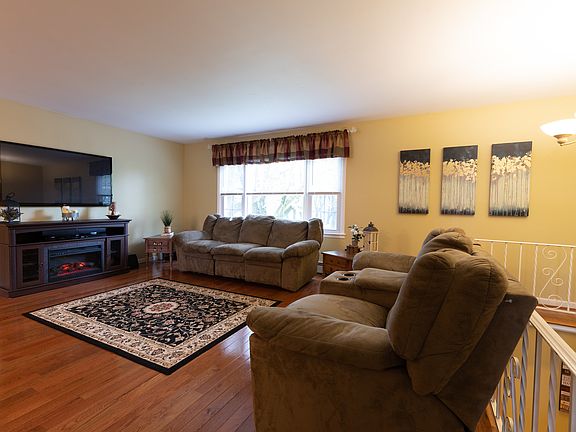 Gleaming hardwood floors accent the living room.