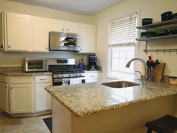 Renovated kitchen w/eat-in breakfast bar and granite countertops.