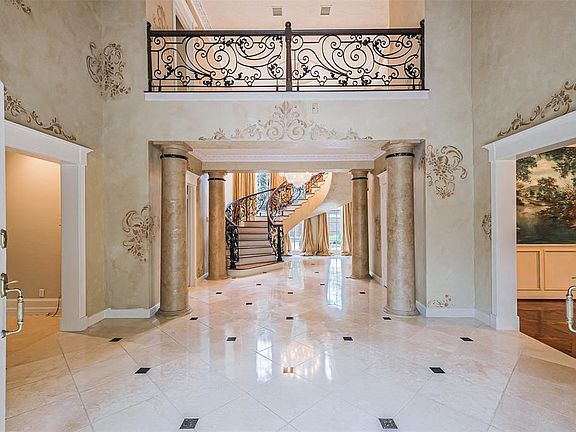 As you enter the grand foyer you are welcomed by a flood of natural light. The floor to ceiling windows encase the floating staircase to provide an overwhelming entry.