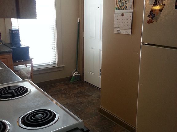 Kitchen looking toward entry door. Walking track outside large window