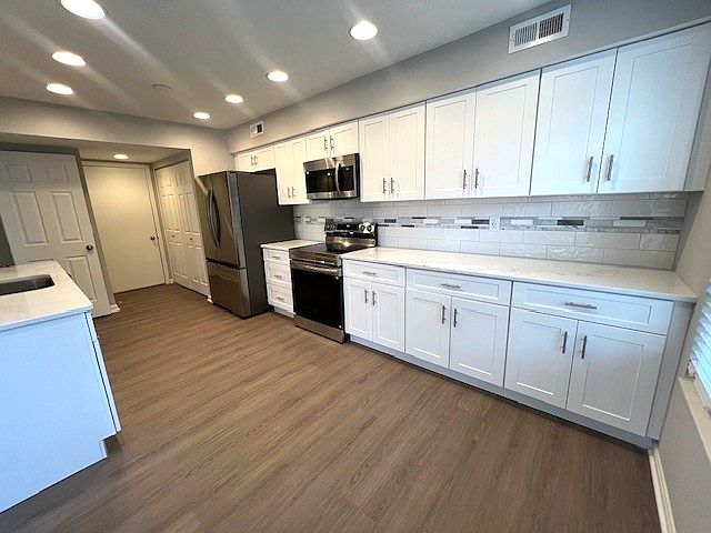 Featuring clean lines, custom cabinetry, and state-of-the-art appliances, this kitchen was designed with both beauty and utility in mind. A fresh, sophisticated space made for everyday living and effortless entertaining.