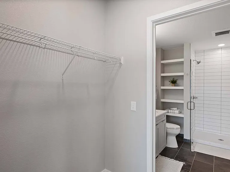 Discover a convenient closet that seamlessly leads to the bathroom.