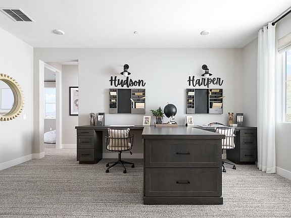 A modern and minimalist home office space with dark furniture, wall decor, and a bright, airy atmosp