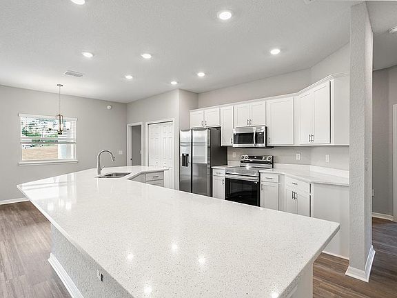 Enjoy a bright and open kitchen with a large island, pantry, and ample counter space - Willow II by