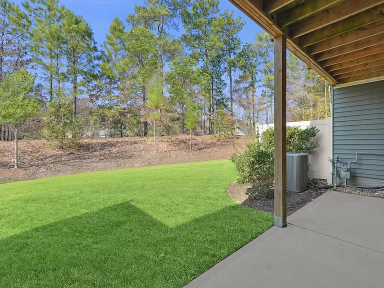 Patio walkout to private yard, featuring partition for added privacy without sacrificing openness