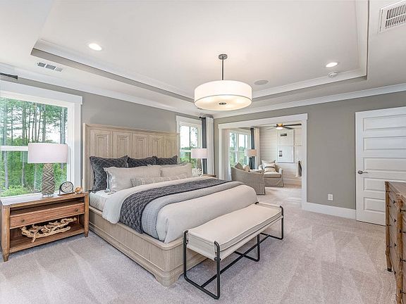 Bright and spacious Owner s Suite with tray ceiling and room to relax