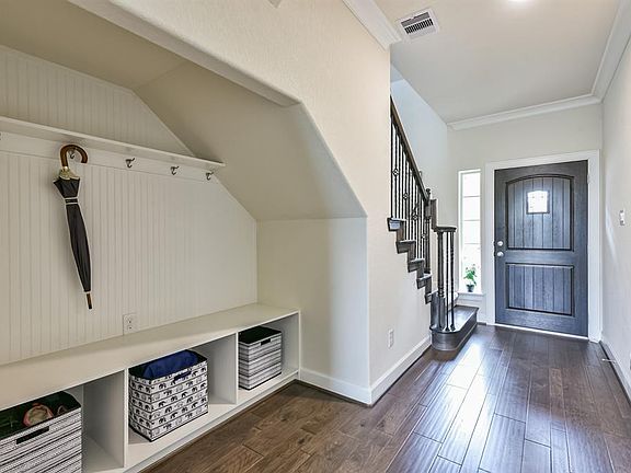 "Mudroom" style shelving with hanging space and cubicles to hold coats, backpacks and shoes!