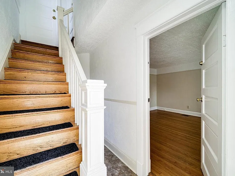 Vestibule with stairs to the second unit. The door opens to the first unit.