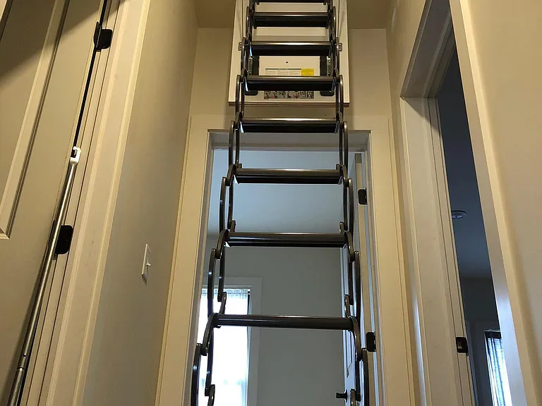 Pull down access to large attic for personal storage.