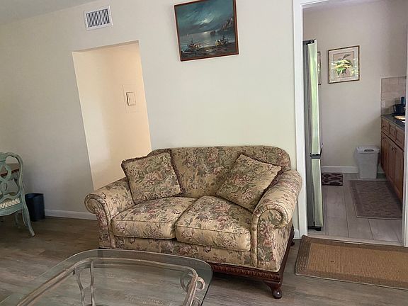 Living room, kitchen to the right and hall to bathroom and bedroom on the left.