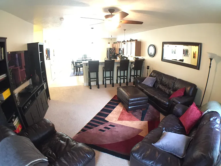 Photo before the flooring was replaced -- showing an example of the furnished living room.
