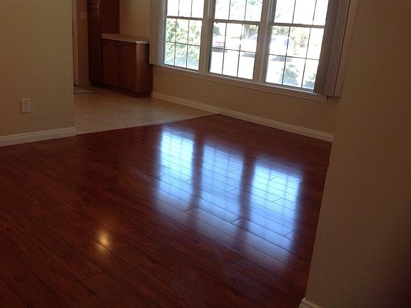 Family room windows and hardwood flooring throughout house.