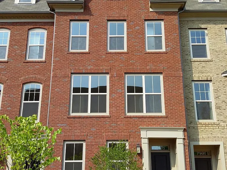 4-Level townhouse with brick front and landscaped front yard.