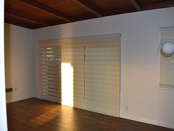 Living room - 3 panel sliding back door with adjacent formal dining area.