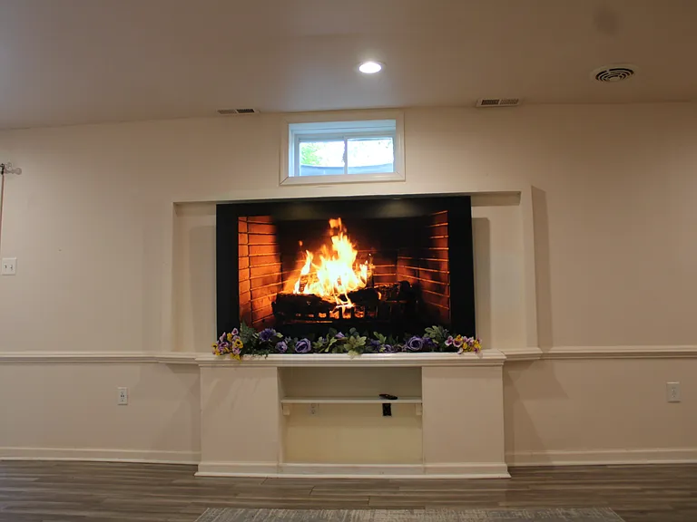 Fully finished basement includes large screen TV