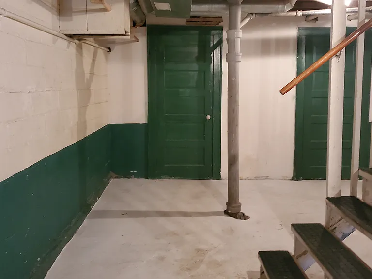 Large clean basement with laundry and plenty of storage.