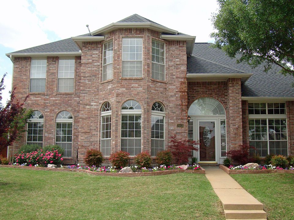 Gorgeous curb appeal with mature trees and meticulous landscaping.