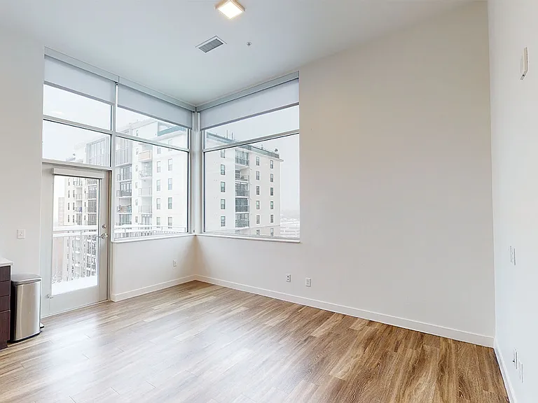 Living room with wood-style flooring and balcony or patio.