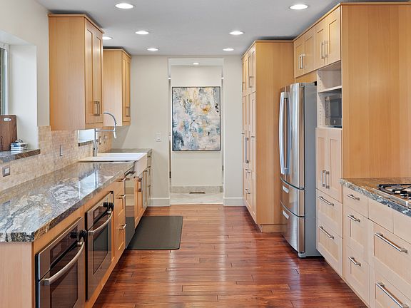 Double ovens. Timeless cabinetry (finally--something that isn't all white). Beautiful wood floors. Gorgeous marble. Stainless steel appliances. It's everything one could want in a kitchen.