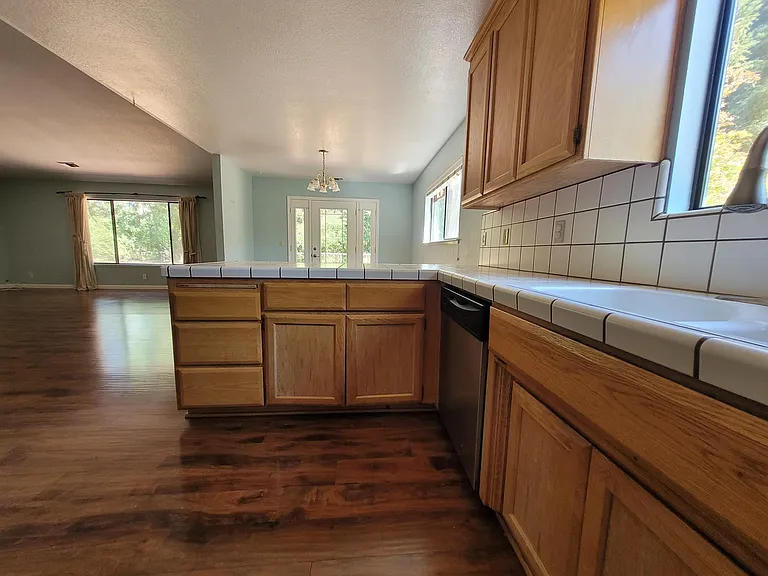 The kitchen has NEW White Granite, and cabinets have been painted White.