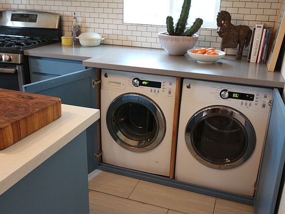 Washer and dryer are tucked away under the kitchen counter
