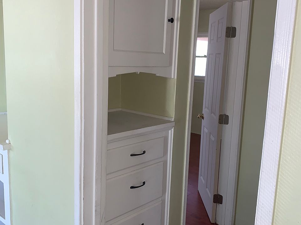 hallway with built in cabinets and drawers