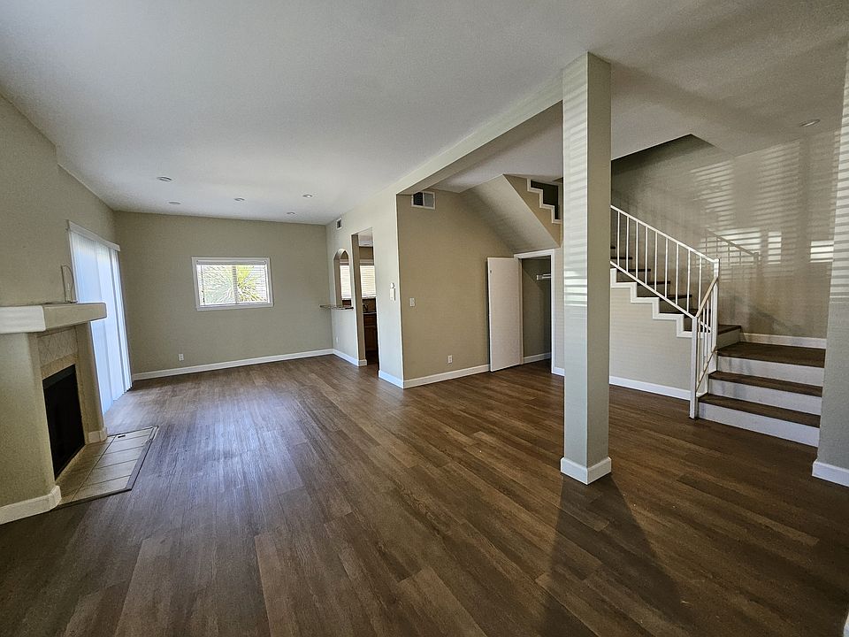 Living room, dining nook, and stairs to bedrooms