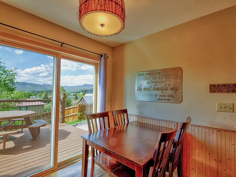 Dining area with a sliding glass door leading onto the deck.