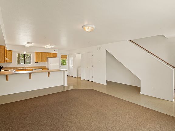 Large & spacious living room-kitchen. Stairway to bedrooms/bathrooms is at the front door.