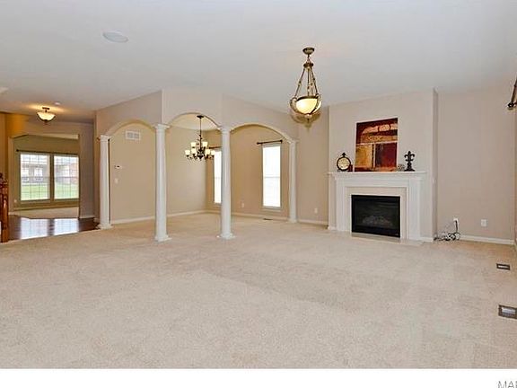 Large Greatroom with Dining Area defined by columns. Gas direct vent fireplace