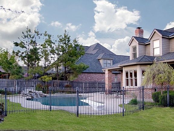 Large backyard with heated diving pool & waterfalls