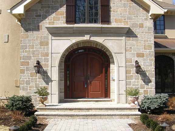 Close up of the paver walkway leading to arched front doors