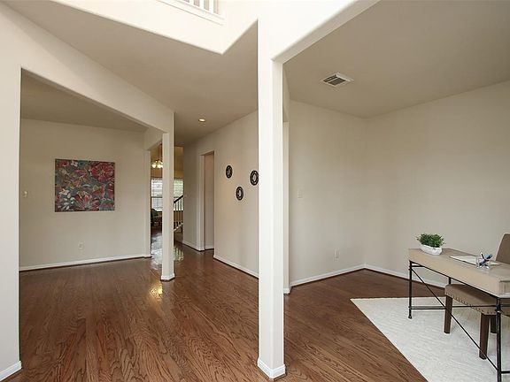 This inviting 2-story foyer with extensive hardwood flooring is flanked by the study to the right and formal dining room to the left. Fresh paint throughout.