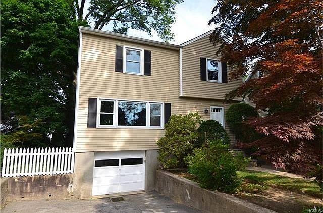 Front entry with garage and driveway parking for 4 cars.