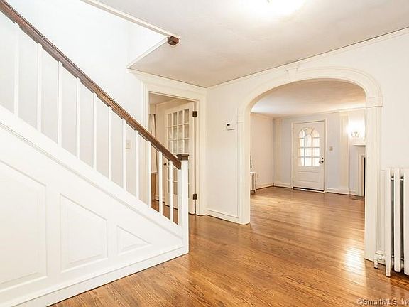 Beyond the foyer, the house opens to a lovely wide Living Room and formal Dining Room.