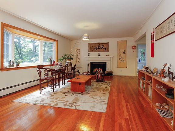 Sun Drenched Living Room with Fireplace and Bay Wi