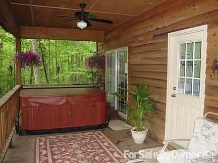 Back porch with hot tub : partial view of back porch. Large gas grill and patio set on opposite end.