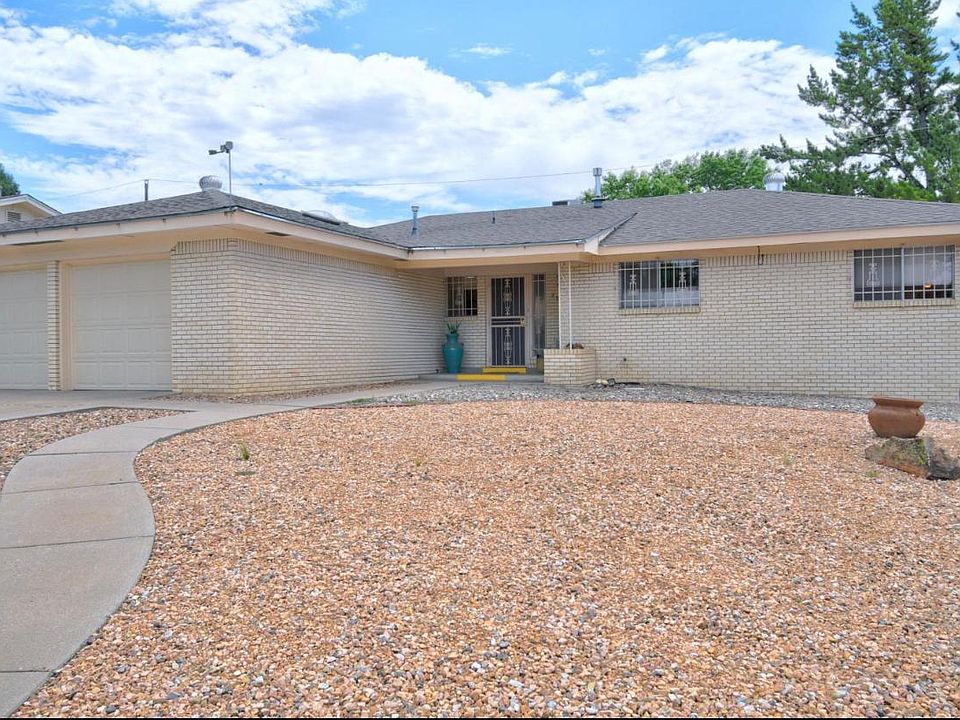 Front of house with low maintenance landscaping. Entire house is brick.