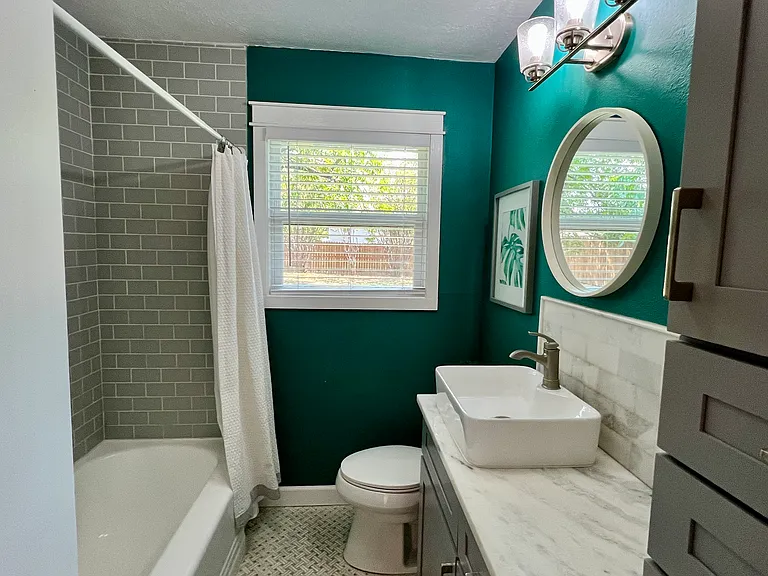Bathroom
Features: Grey shaker cabinets with soft close doors and drawers, marble countertop, marble mosaic on the floor and shower.