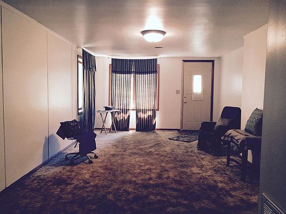 Large Living area with window treatments and ceiling light