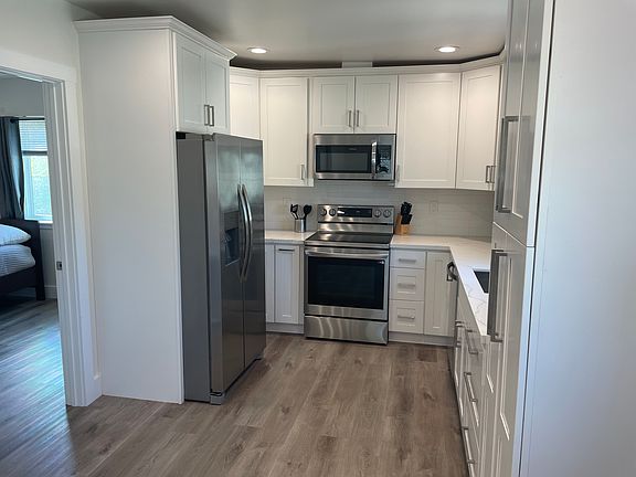 New kitchen appliances, Refrigerator with water and ice maker, microwave, oven/stove with air fryer, dishwasher and plenty of cabinets for storage.
