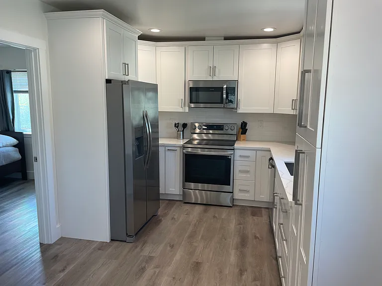 New kitchen appliances, Refrigerator with water and ice maker, microwave, oven/stove with air fryer, dishwasher and plenty of cabinets for storage.