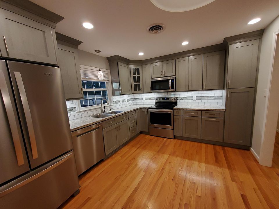 NEW CUSTOM KITCHEN! Stainless appliances, solid wood cabinets, tile backsplash, lighting, granite-like countertops, pantry cabinets, hardwood floors, etc. Gorgeous!