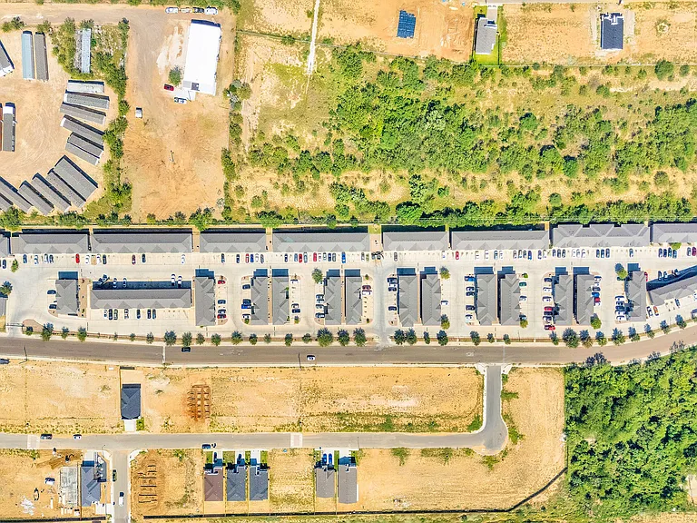 212_Obsidian_D-7 - Aerial view of a large parking lot at La Joya Apartments in Laredo, Texas, showcasing numerous parked vehicles