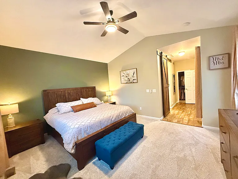 Main floor primary bedroom - view to hallway and walk in closet