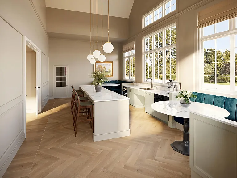 Community gathering kitchen with an oversized island, banquette seating, and tall windows that bring in natural light for casual meetups and events.