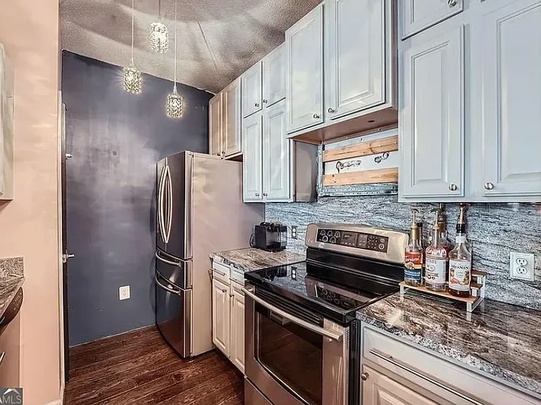 Generous cabinet space for plenty of storage. Dedicated pantry facing refrigerator. (Above stove microwave has since been added).