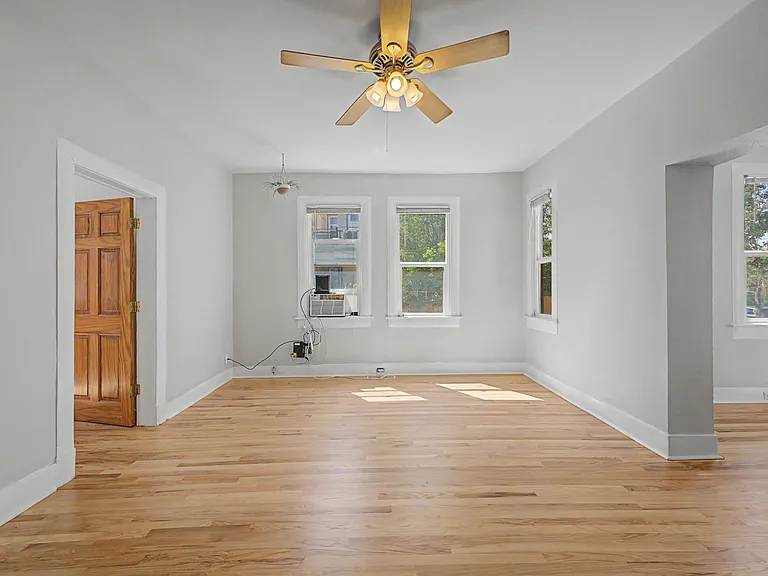 two adjoining living rooms, full of windows